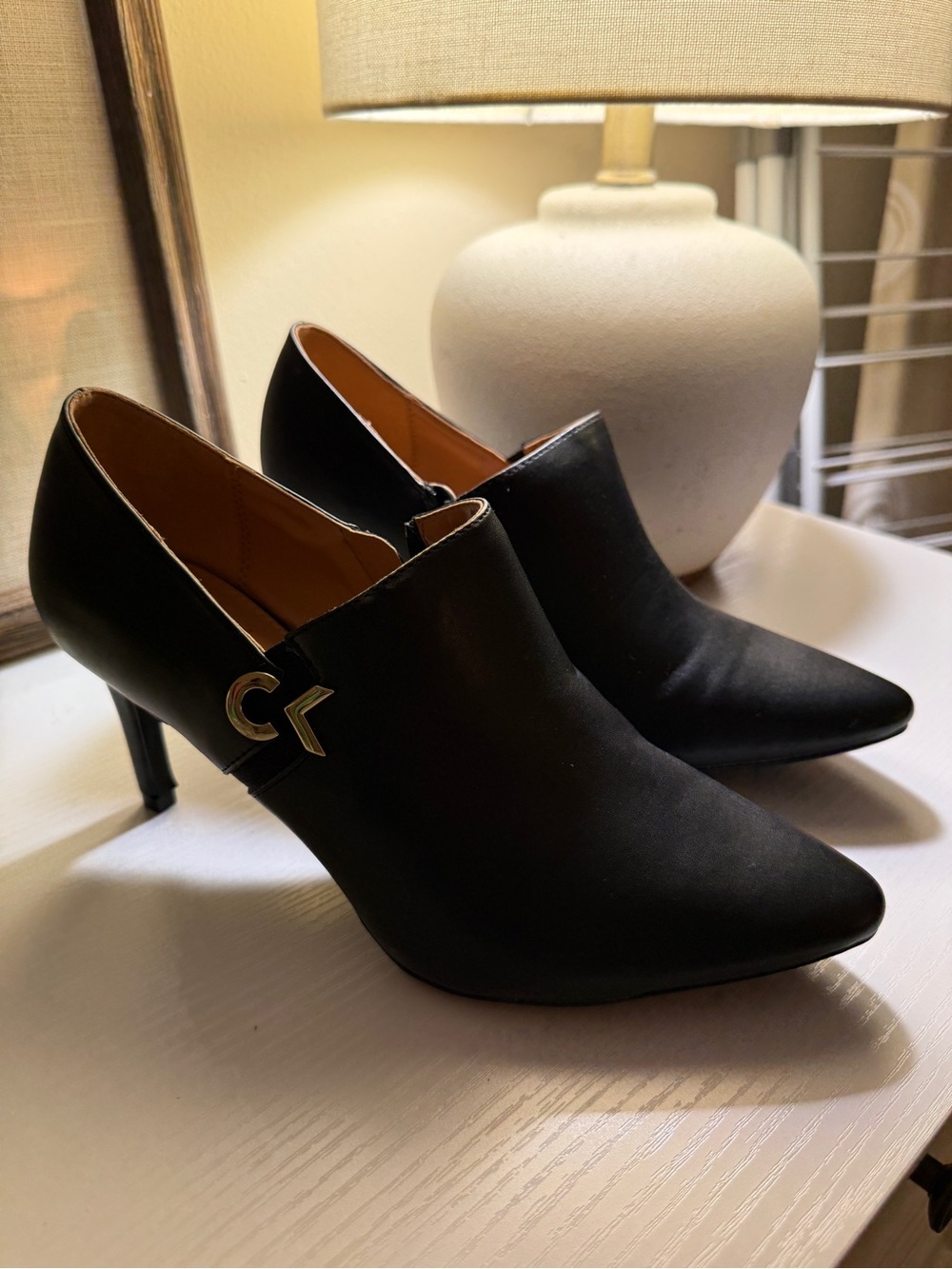 Calvin Klein Black Pointed Toe Heeled Ankle Booties with Gold CK Accent
